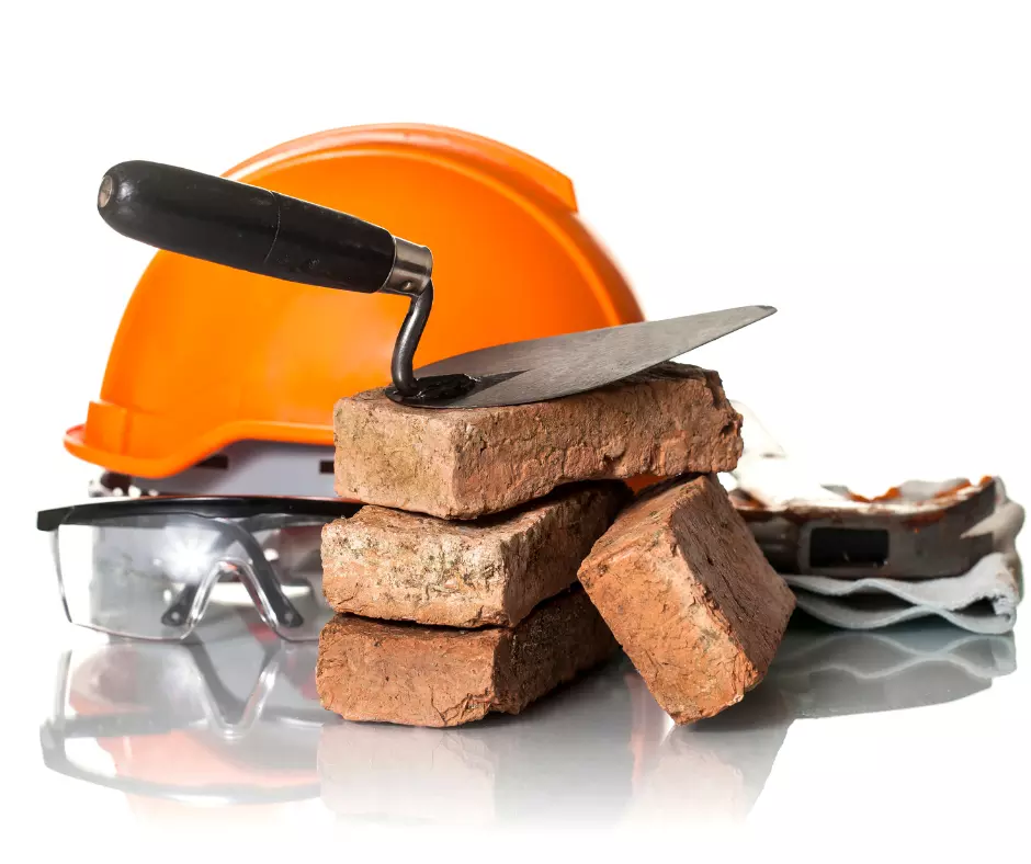 Herrramientas de construccion apliadas sobre algunos ladrillos